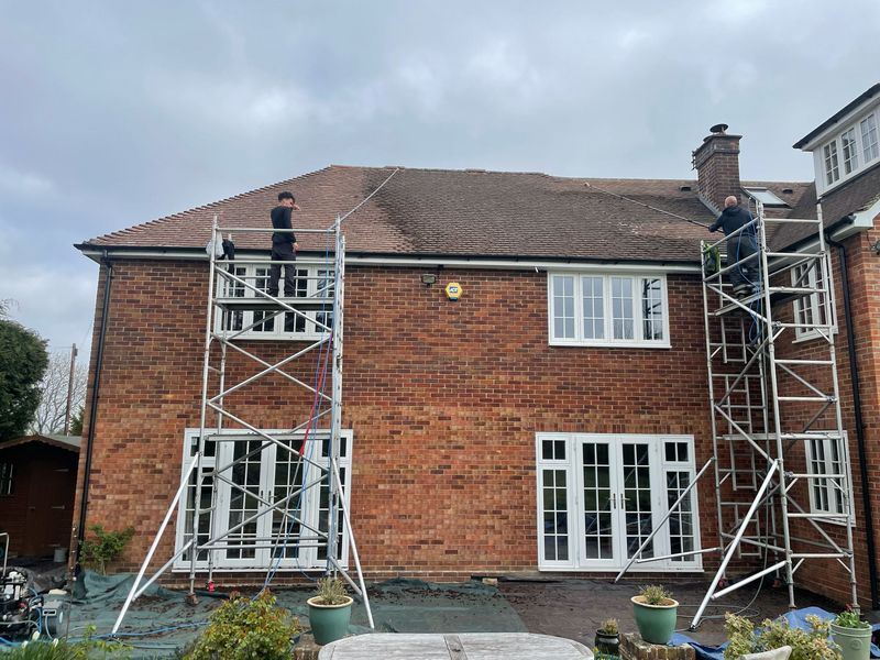 Roof cleaning carried out safely from scaffold towers by The Roof Moss Cleaners in Woking